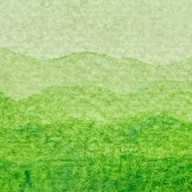 Gradient of Key Lime green watercolor shades on a textured watercolor paper