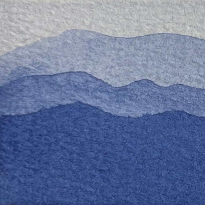 Gradient of midnight blue watercolor shades on a textured watercolor paper