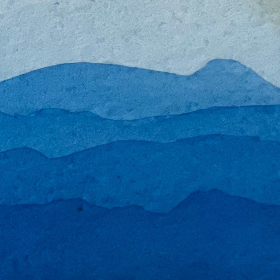 Layered phthalo blue gradient swatch on textured watercolor paper
