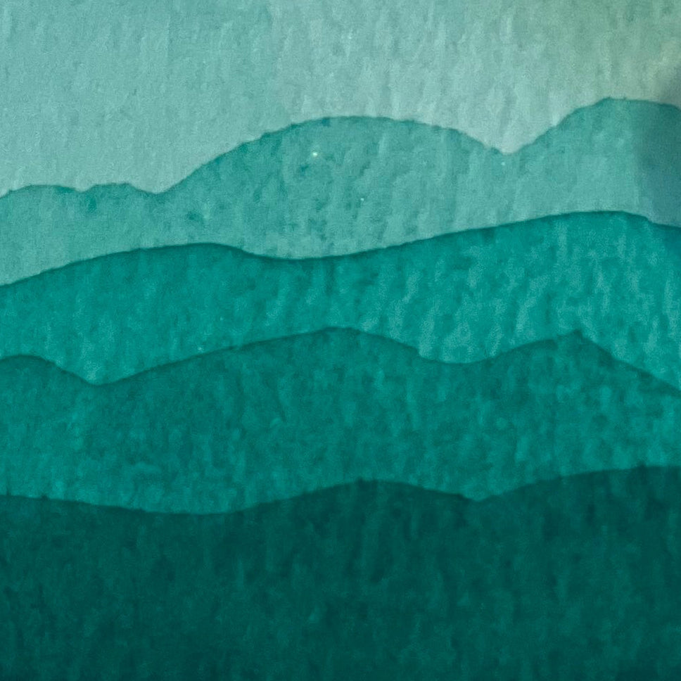 Gradient of phthalo green watercolor shades on a textured watercolor paper