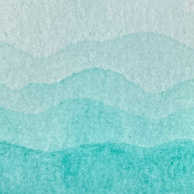 Gradient of seafoam blue green watercolor shades on a textured watercolor paper